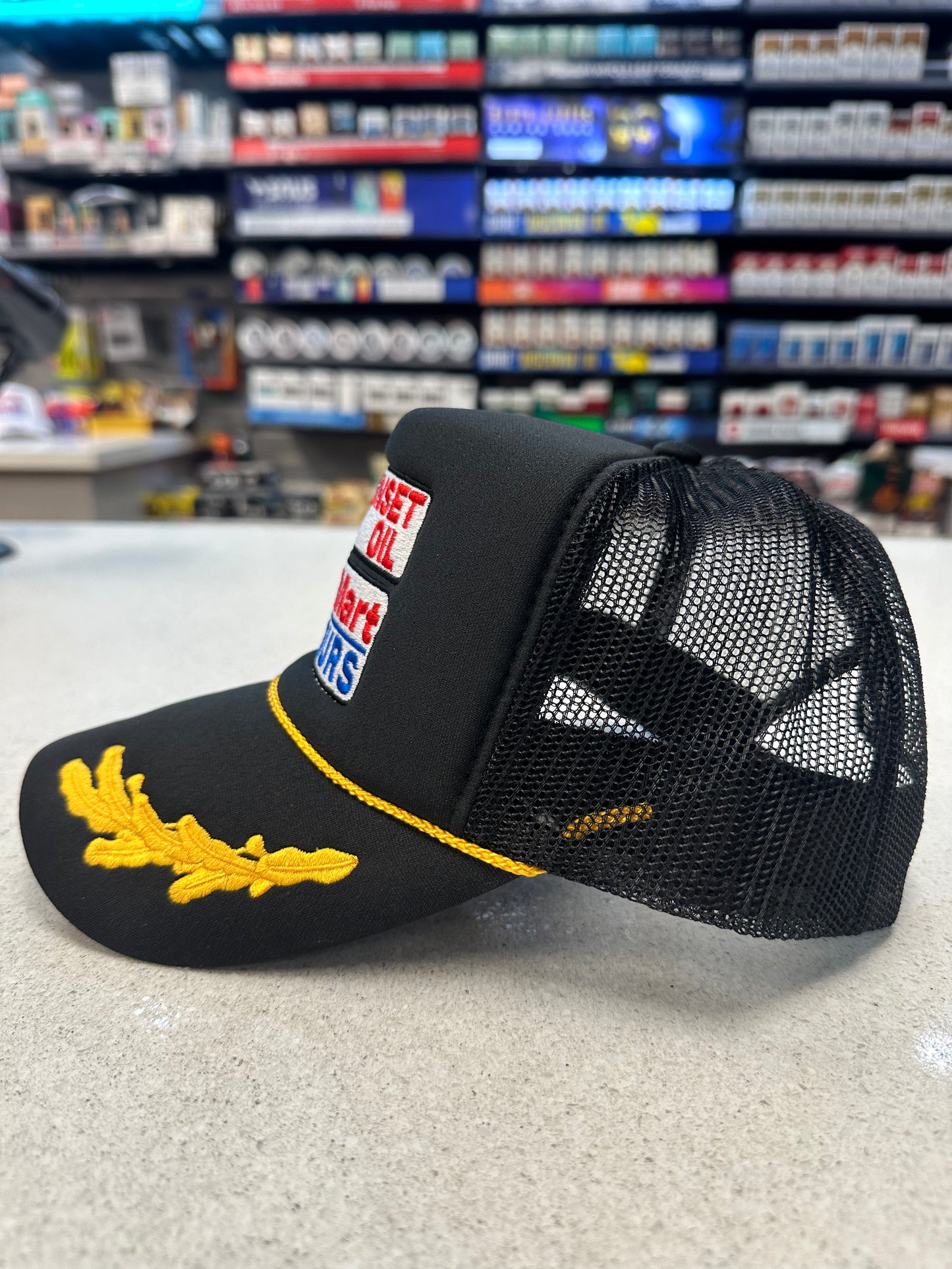 Sunset Oil Mini Mart Black/Gold Leaf Trucker Hat